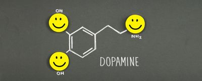 A drawing of a dopamine molecule with happy faces.