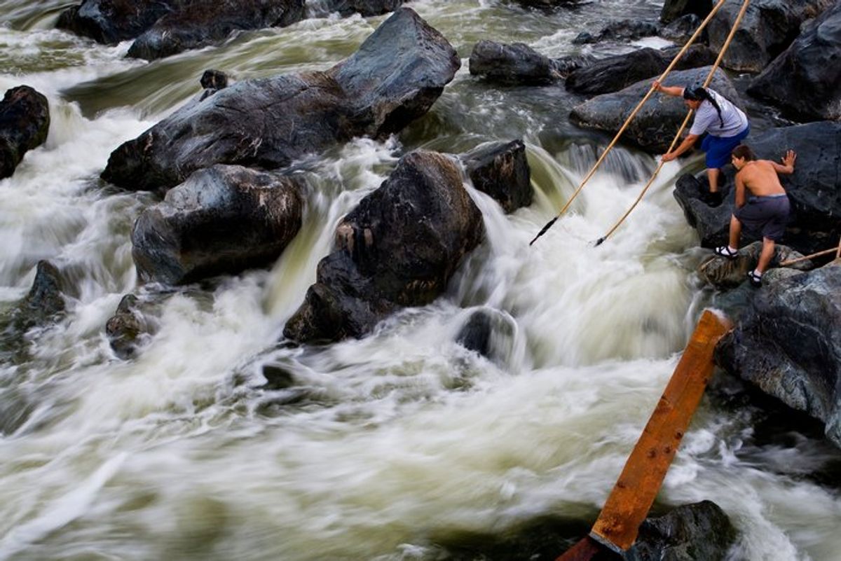 Photo of Ron Reed fishing for salmon at Ishi Pishi Falls with a dip net Photo of Ron Reed fishing for salmon at Ishi Pishi Falls with a dip net