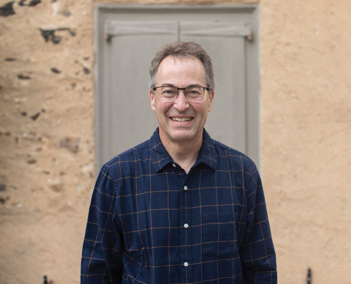 A man wears a plaid shirt and glasses. A man wears a plaid shirt and glasses.