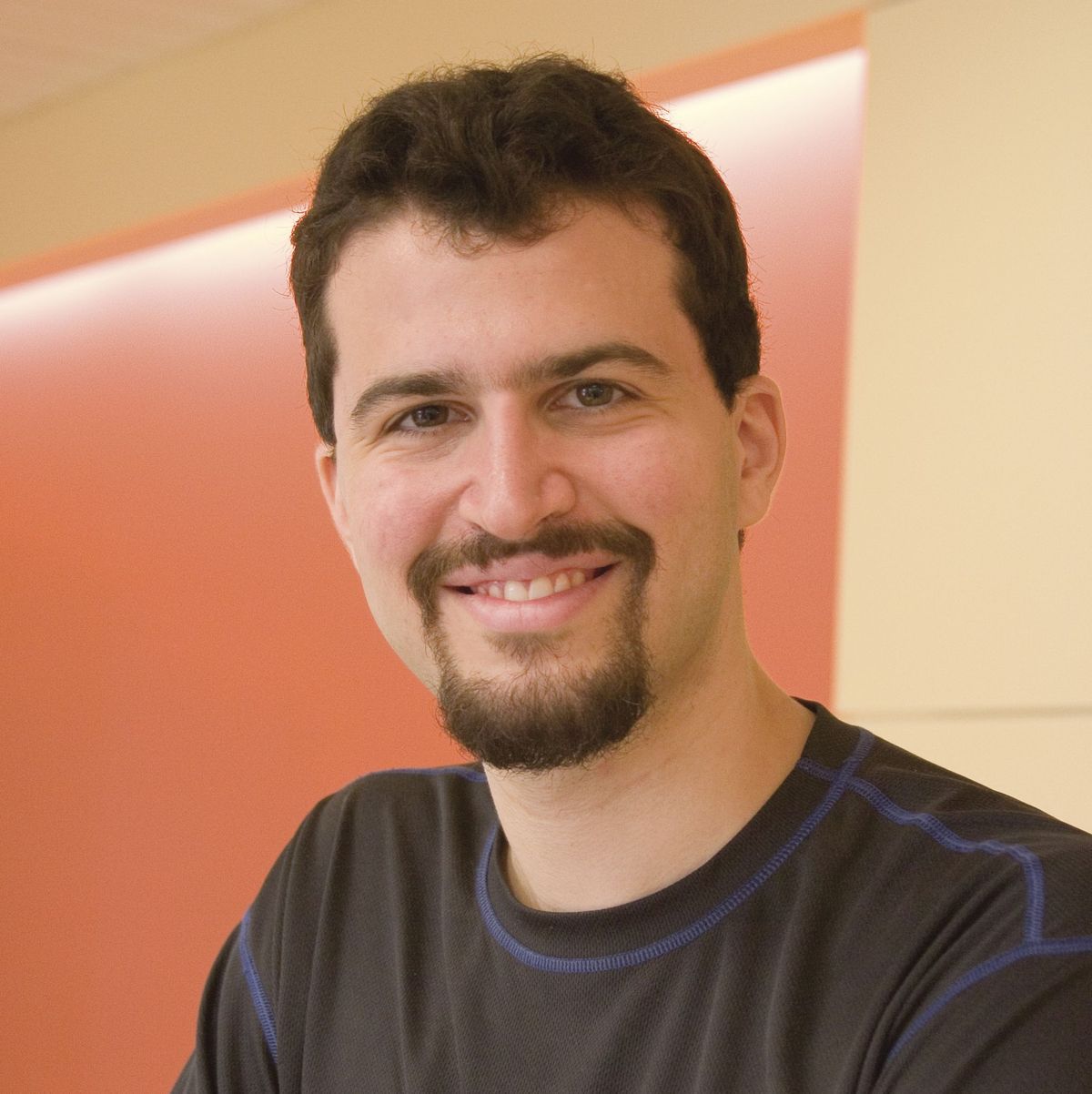 Image of Erez Lieberman Aiden, a molecular geneticist at Baylor College of Medicine, who is involved in researching 3D structure of genomes. He wears a black shirt and smiles at the camera. Image of Erez Lieberman Aiden, a molecular geneticist at Baylor College of Medicine, who is involved in researching 3D structure of genomes. He wears a black shirt and smiles at the camera.