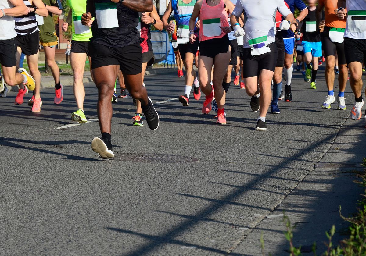 Image showing the legs of multiple people running in the street. Image showing the legs of multiple people running in the street.