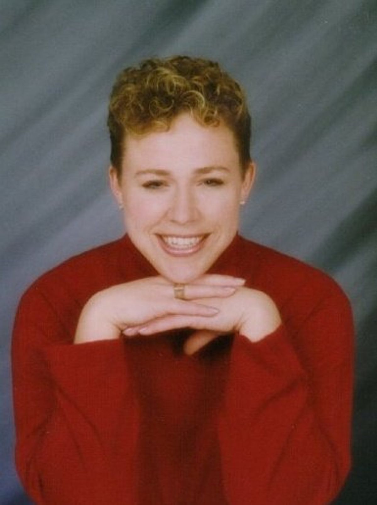 Photograph of a Julia Darby, currently a private tutor for school districts in Iowa and Illinois, learned that her convenient protein tags may have done more than she bargained for. She is wearing a red shirt and smiles at the camera with her hands folded under her chin. Photograph of a Julia Darby, currently a private tutor for school districts in Iowa and Illinois, learned that her convenient protein tags may have done more than she bargained for. She is wearing a red shirt and smiles at the camera with her hands folded under her chin.