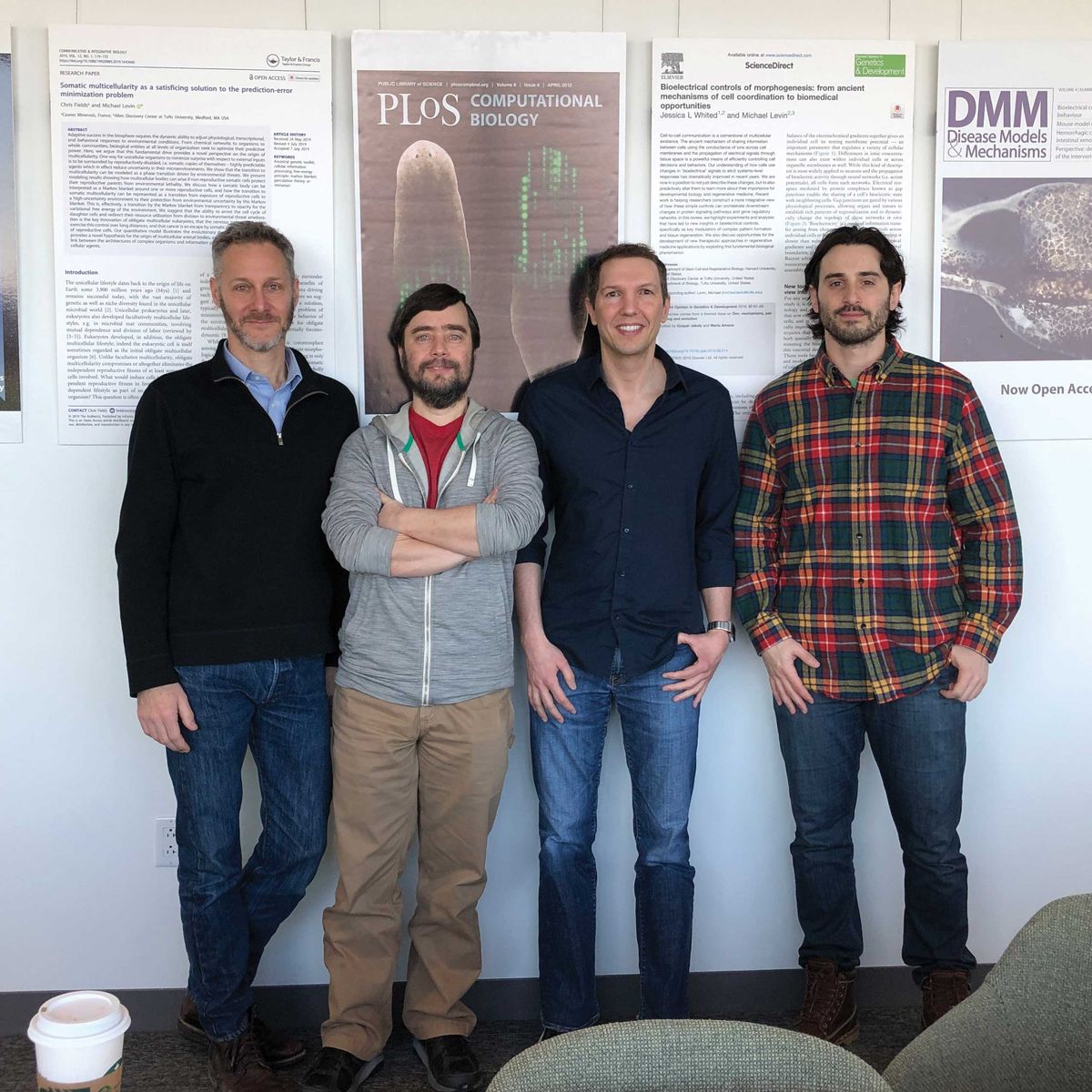 Group photo of four men standing side by side. Group photo of four men standing side by side.